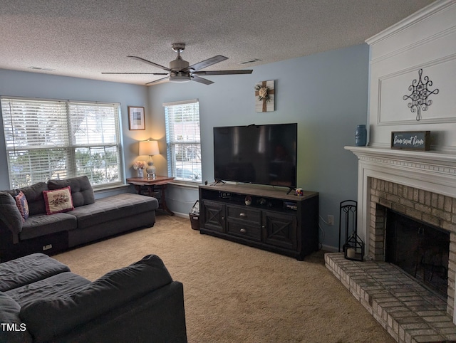 carpeted living room featuring ceiling fan, a brick fireplace, and a textured ceiling