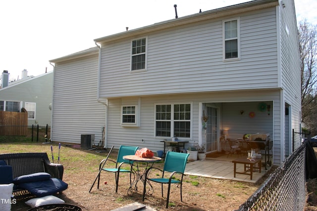 rear view of property featuring cooling unit and a patio