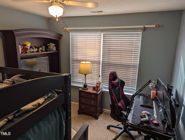 carpeted bedroom featuring multiple windows and a textured ceiling