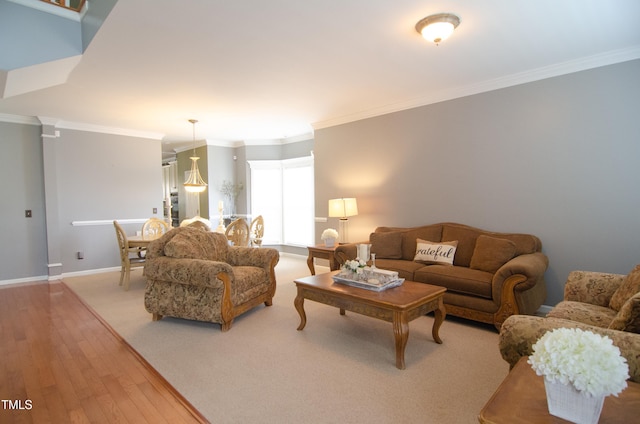 living room with ornamental molding and light wood-type flooring