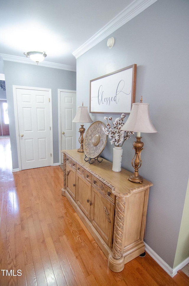 corridor featuring crown molding and light wood-type flooring