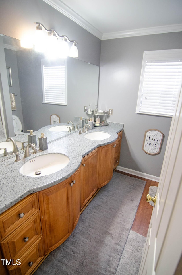 bathroom featuring ornamental molding, toilet, hardwood / wood-style floors, and vanity