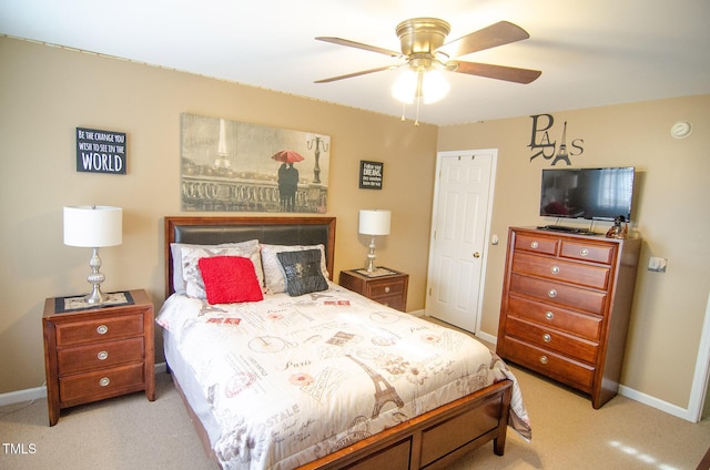 bedroom with ceiling fan and light carpet