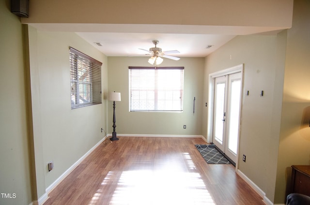 foyer entrance with ceiling fan and light hardwood / wood-style flooring