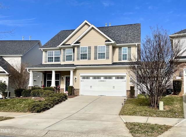 view of front of house featuring a garage and a porch