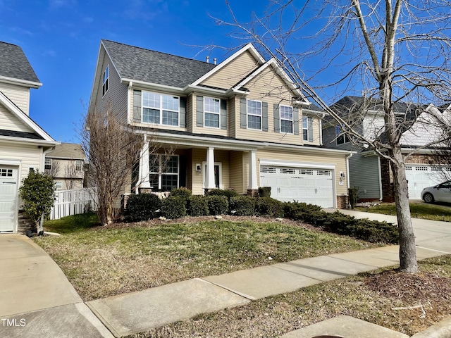 view of front of property with a garage and a front lawn