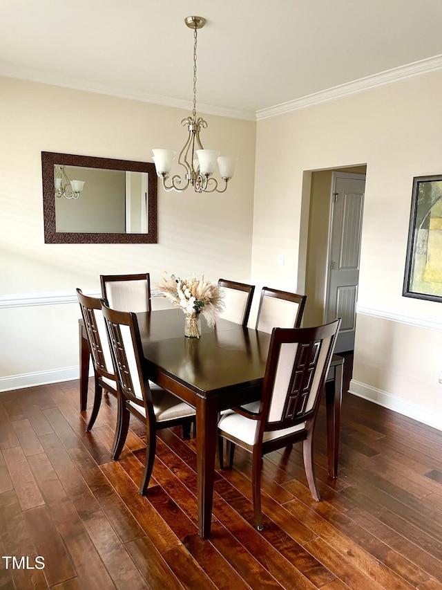 dining area with ornamental molding, an inviting chandelier, and dark hardwood / wood-style flooring