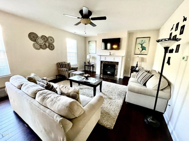 living room featuring ceiling fan, dark wood-type flooring, and a high end fireplace