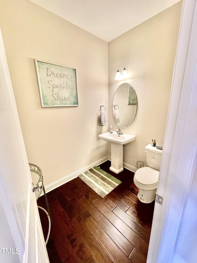 bathroom with wood-type flooring and toilet