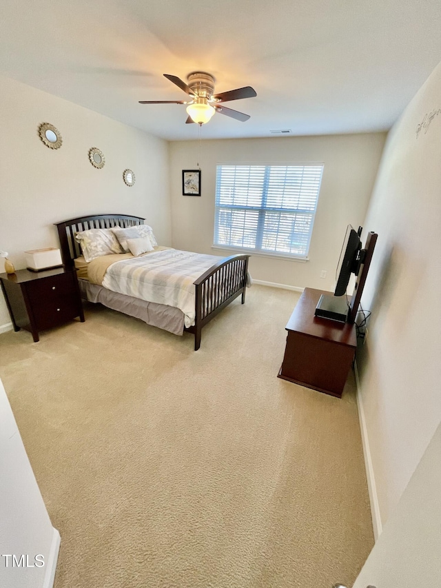 bedroom featuring light colored carpet and ceiling fan