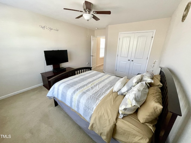 carpeted bedroom featuring a closet and ceiling fan