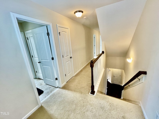 hallway with light colored carpet