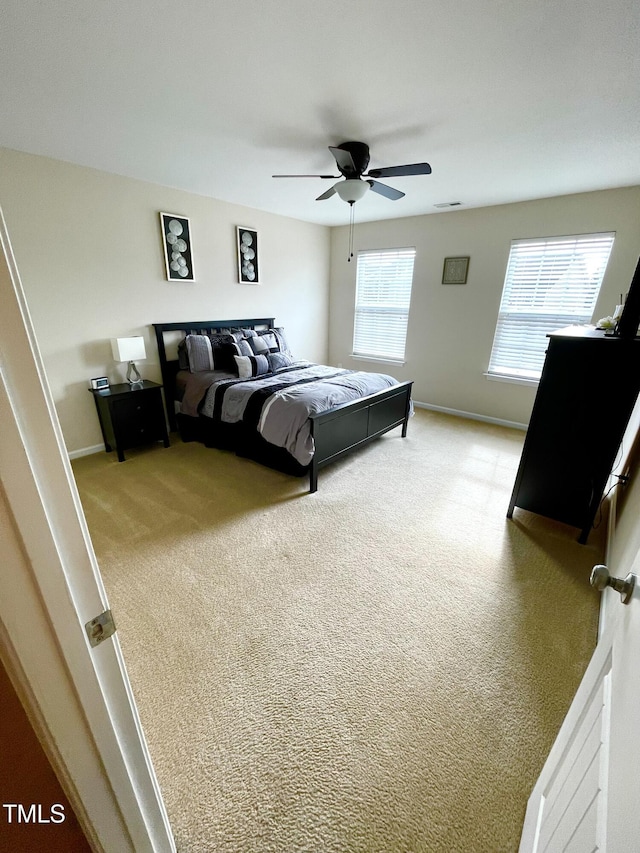 carpeted bedroom with ceiling fan