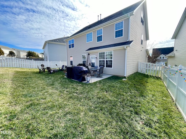 rear view of house featuring a yard and a patio area