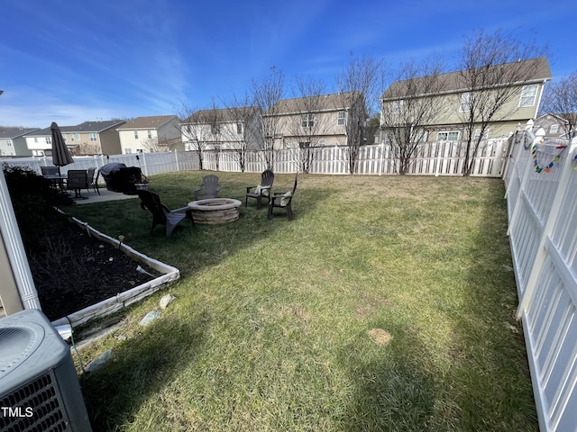 view of yard with cooling unit and an outdoor fire pit