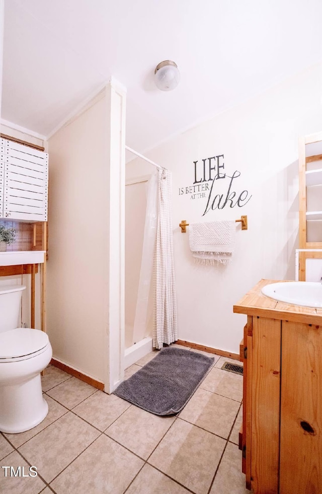 bathroom with tile patterned flooring, toilet, vanity, and a shower with shower curtain