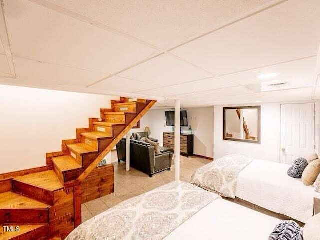 bedroom featuring a paneled ceiling