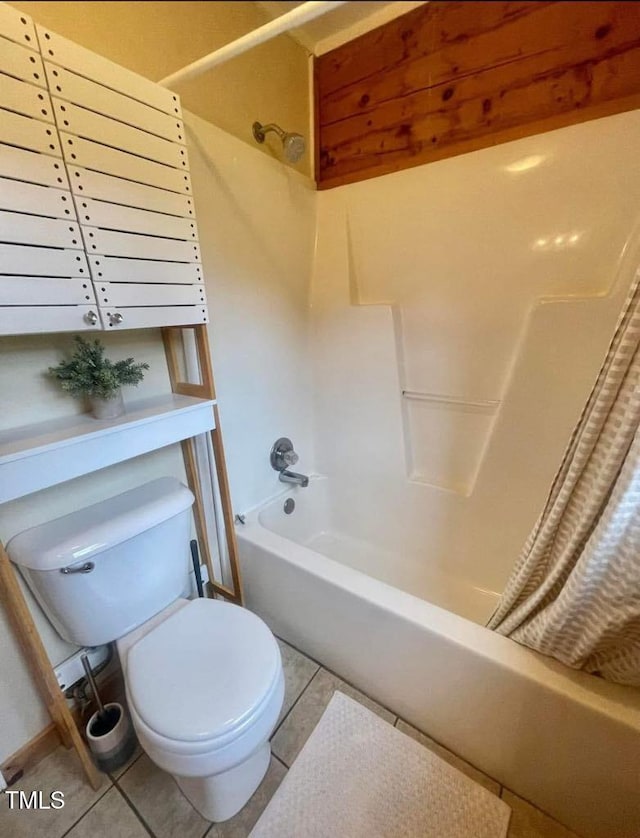 bathroom featuring shower / bathtub combination, tile patterned floors, and toilet