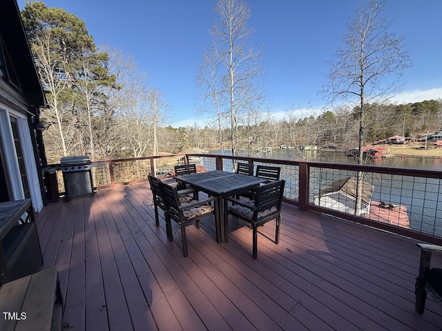 wooden deck featuring area for grilling and a water view