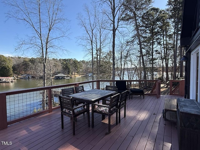 wooden terrace featuring a water view