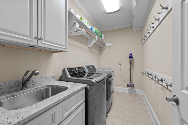 laundry room with sink, cabinets, washer and dryer, light tile patterned floors, and ornamental molding