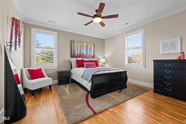 bedroom with ceiling fan, ornamental molding, and hardwood / wood-style floors