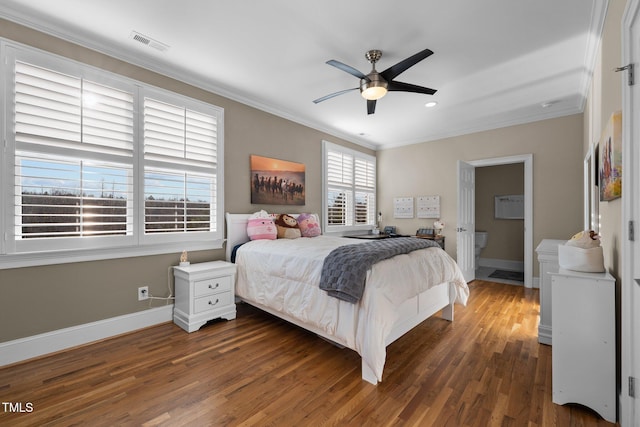 bedroom featuring crown molding, ceiling fan, dark hardwood / wood-style flooring, and ensuite bath