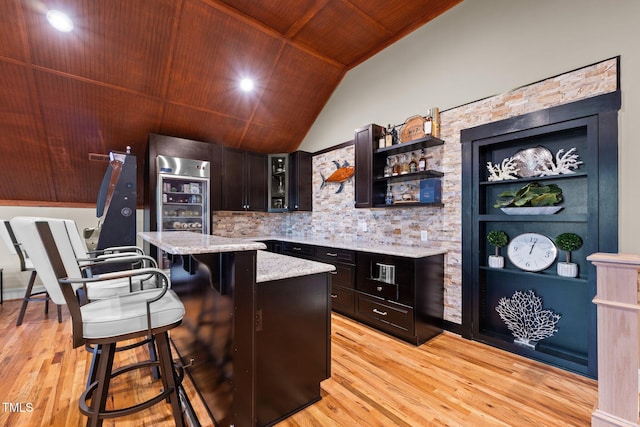 bar with dark brown cabinetry, lofted ceiling, wood ceiling, and light hardwood / wood-style floors