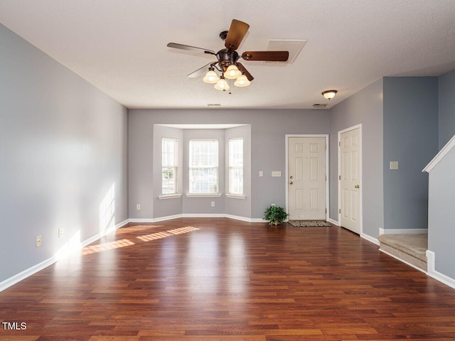 empty room featuring dark hardwood / wood-style flooring and ceiling fan