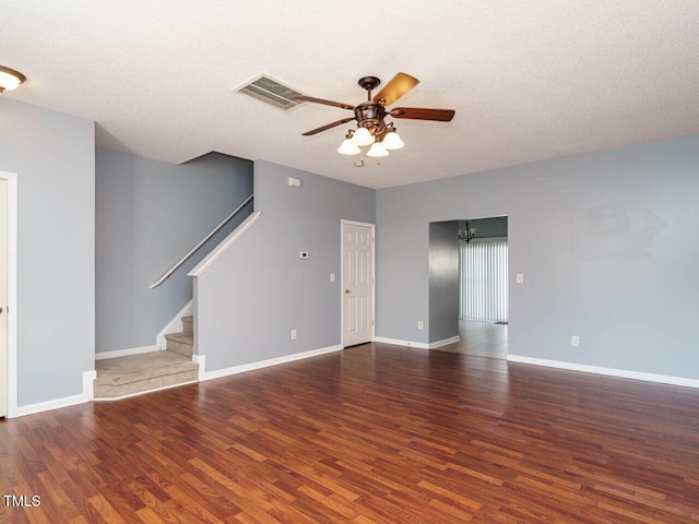 unfurnished living room featuring ceiling fan, a textured ceiling, and dark hardwood / wood-style flooring