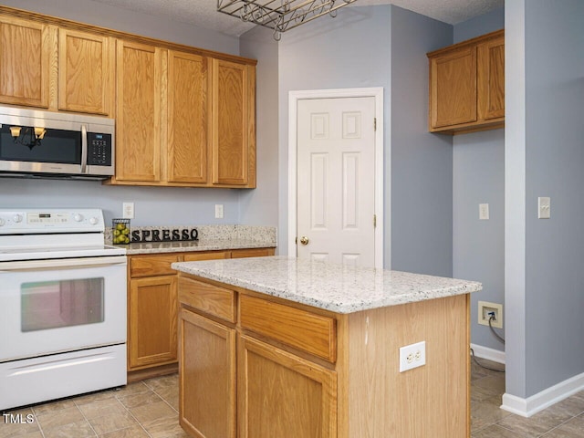 kitchen with white range with electric cooktop, a center island, light stone countertops, and a textured ceiling