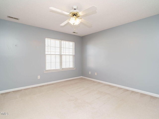 spare room with ceiling fan, carpet flooring, and a textured ceiling