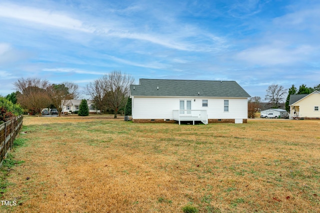 rear view of property with a lawn