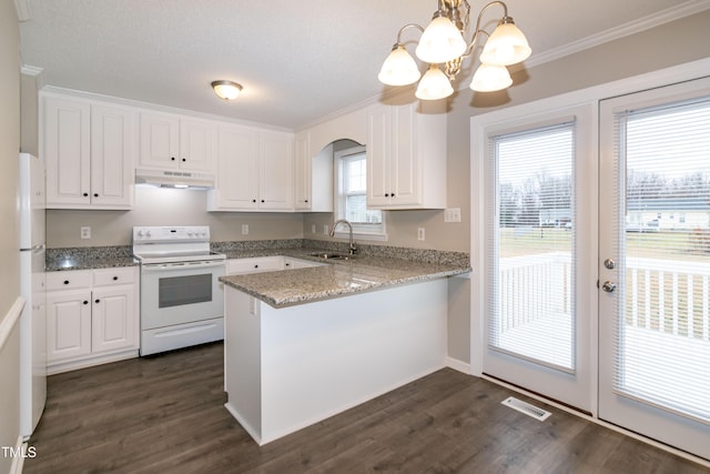 kitchen featuring white cabinetry, pendant lighting, and white appliances