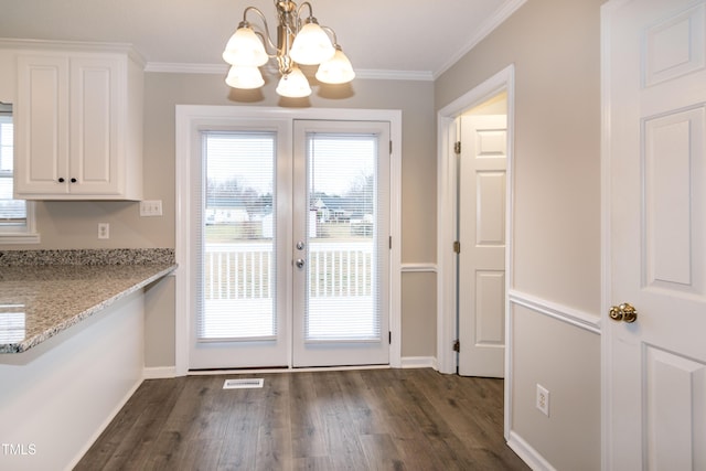 doorway to outside with ornamental molding, dark hardwood / wood-style floors, a chandelier, and french doors