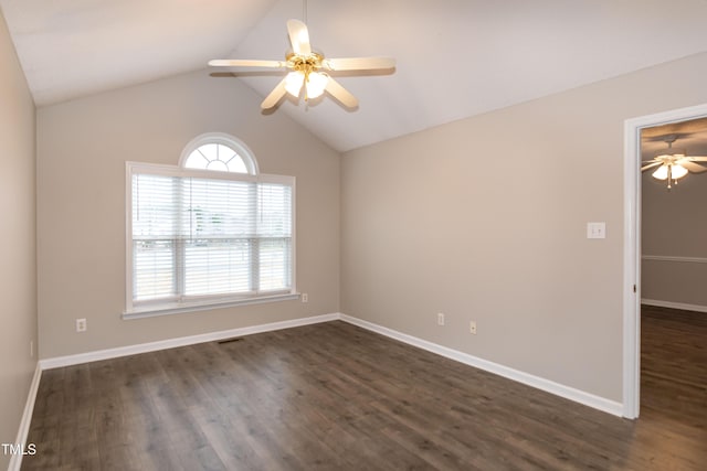 unfurnished room featuring vaulted ceiling, plenty of natural light, dark wood-type flooring, and ceiling fan