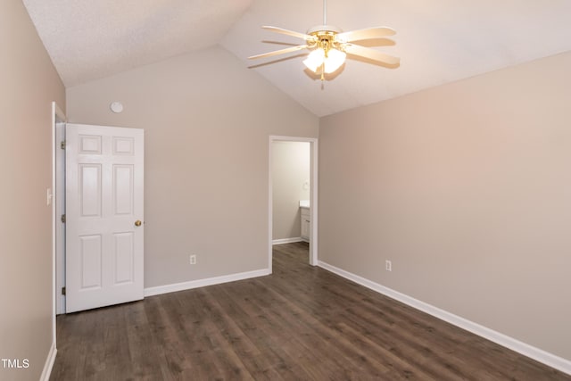 unfurnished bedroom featuring lofted ceiling, dark wood-type flooring, and ceiling fan