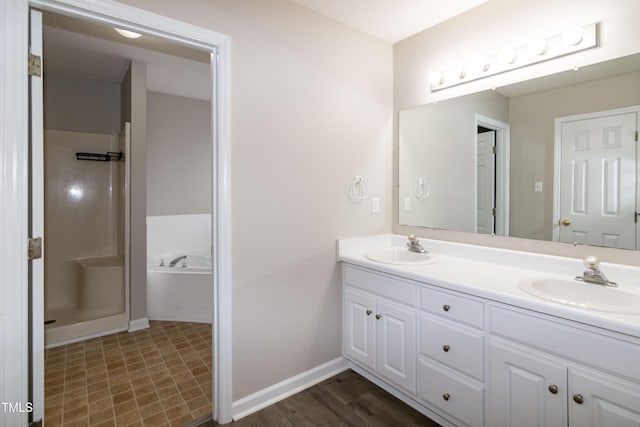 bathroom featuring vanity and tiled tub