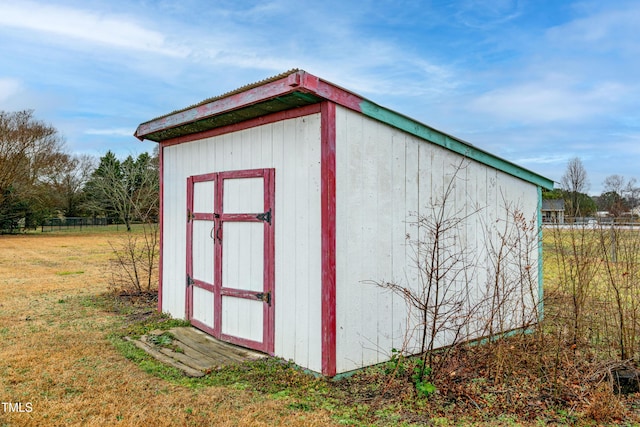 view of outbuilding with a yard