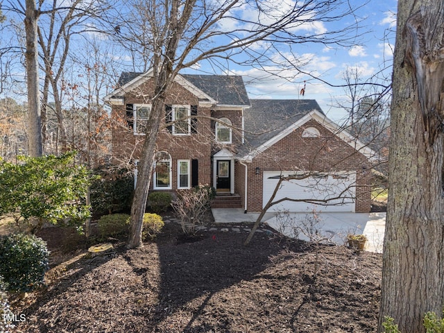 view of front facade featuring concrete driveway, brick siding, and an attached garage