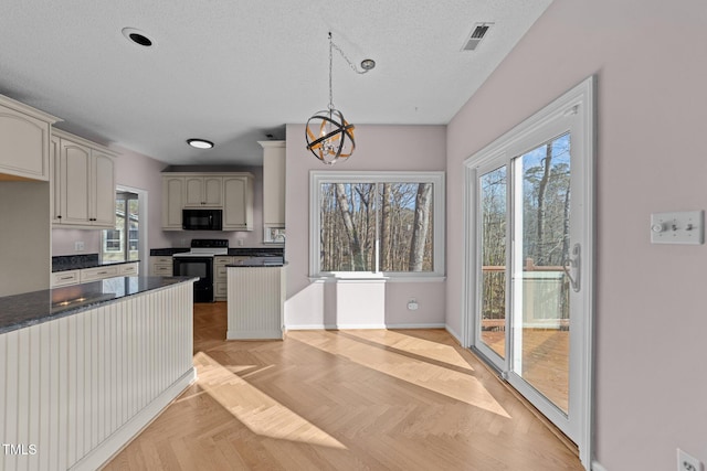 kitchen featuring a textured ceiling, a chandelier, visible vents, black appliances, and dark countertops