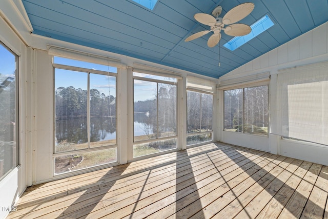 unfurnished sunroom featuring a water view, lofted ceiling with skylight, ceiling fan, and wooden ceiling