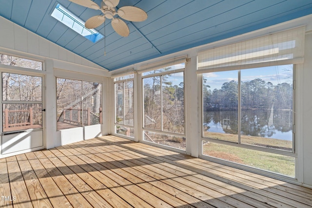 unfurnished sunroom with ceiling fan, lofted ceiling with skylight, and a water view