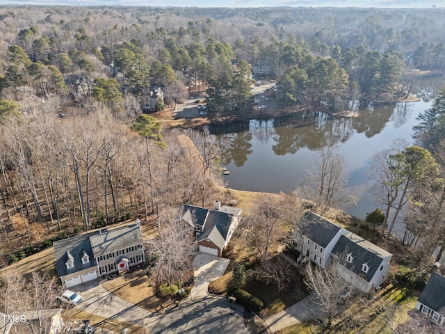 aerial view with a forest view and a water view