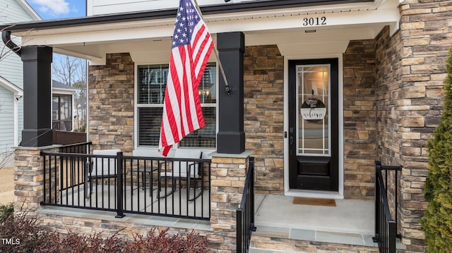 entrance to property featuring a porch