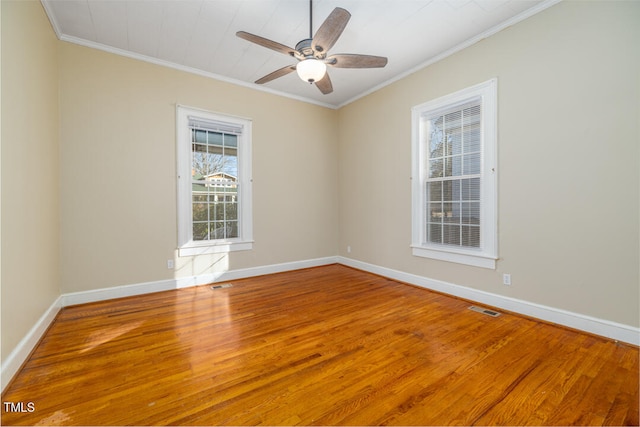 empty room with crown molding, hardwood / wood-style flooring, and ceiling fan