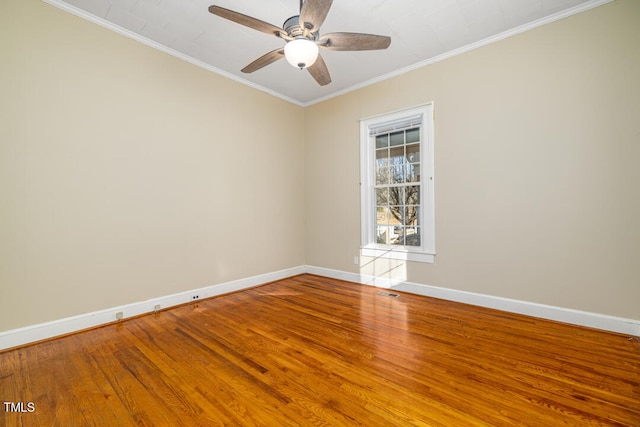 spare room featuring hardwood / wood-style flooring, ornamental molding, and ceiling fan