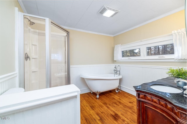 bathroom featuring hardwood / wood-style flooring, ornamental molding, shower with separate bathtub, and vanity