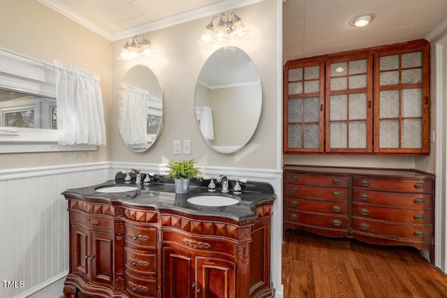 bathroom featuring ornamental molding, wood-type flooring, and vanity