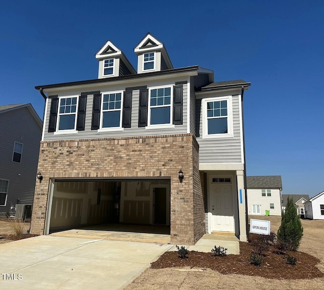 view of front of home with driveway, brick siding, and an attached garage